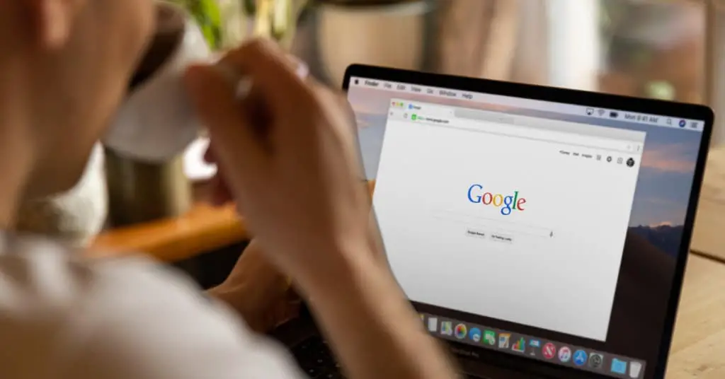 A person using Google search on his laptop