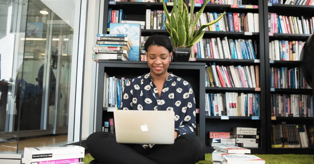 a lady sitting on the floor learning