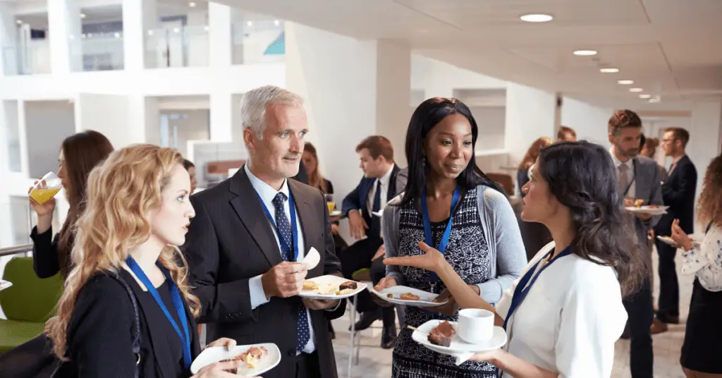 amazon global selling - A group of people discussing creative ways to make money without spending money at a business event.