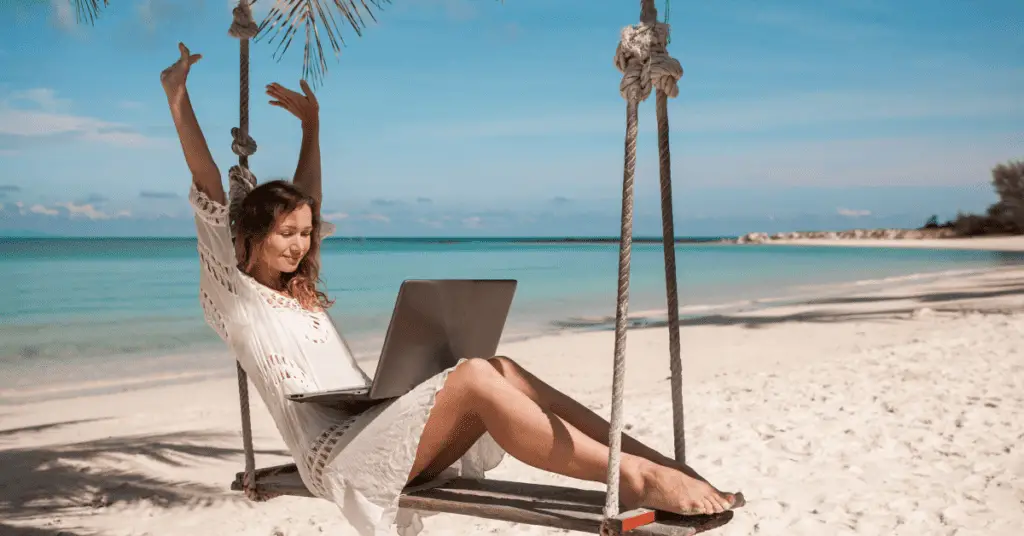 signs you are meant to be an entrepreneur: 
A lady working on her laptop by the beach