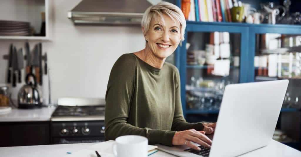 how to find the right business to start -  a woman working in the kitchen on her laptop