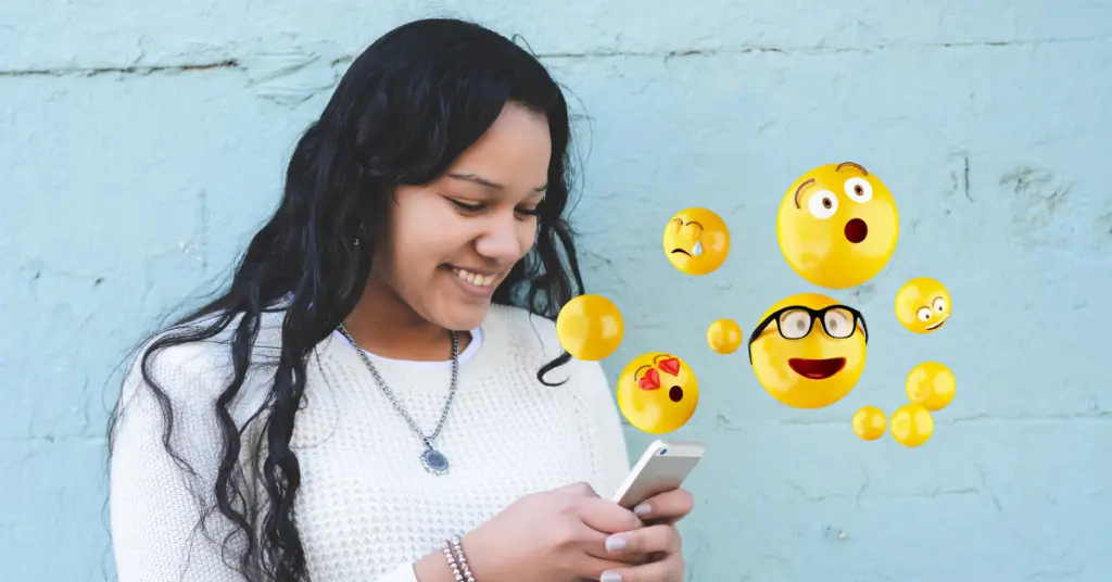 quality email lists - A girl is using a cell phone to communicate with emojis.