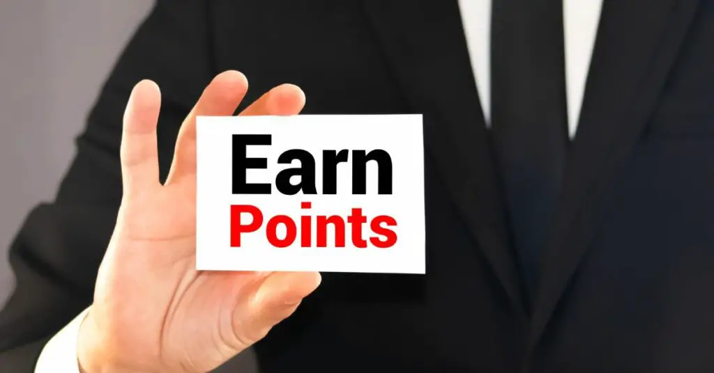 A man showcasing an earn points card for online store promotion ideas.